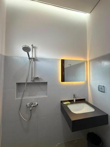 a bathroom with a sink and a mirror at Elbara Guest House Syariah in Banjarbaru