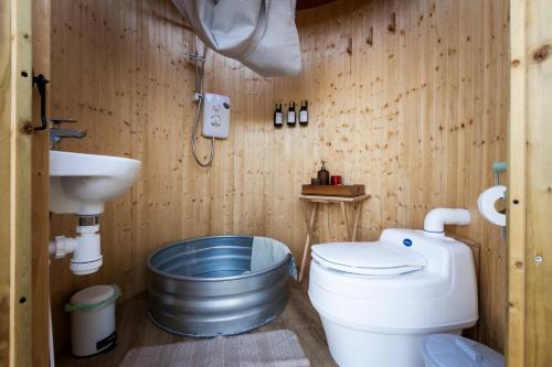 a bathroom with a toilet and a sink at JOY Retreat in Isle of Jersey