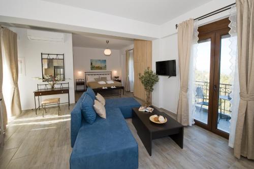 a living room with a blue couch and a table at Olivia Villas in Raches