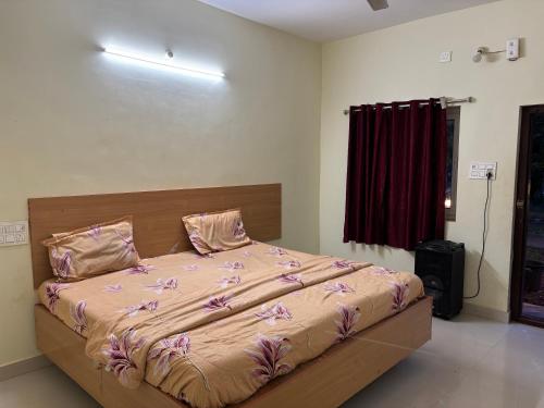 a bedroom with a large bed with pink sheets at Holidaypark Resort Araku in Araku