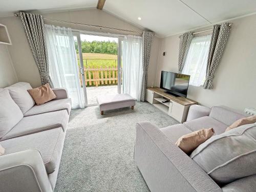 a living room with two couches and a television at Astra - Ukc9718 in Aston