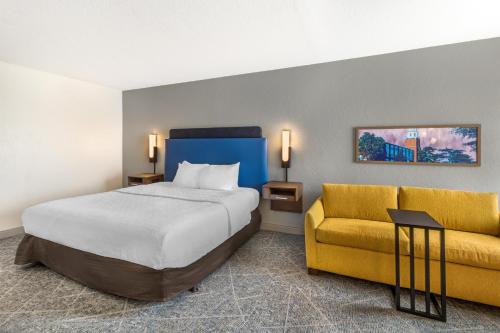 a hotel room with a bed and a couch at Hampton Inn Carbondale in Carbondale