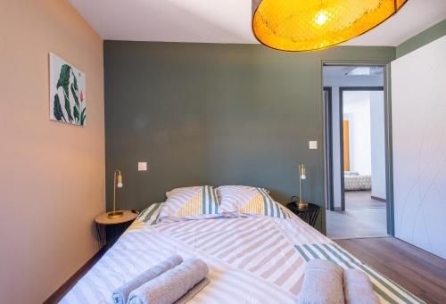 a bedroom with a bed with two towels on it at Gîte de l'escapade in Rieutort