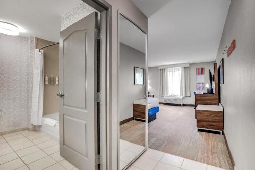 a bathroom with a shower and a sink and a mirror at Hampton Inn and Suites Peru in Peru