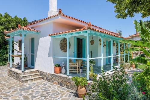 a house with a blue and white at Amaranthos Garden Retreat in Skopelos Town
