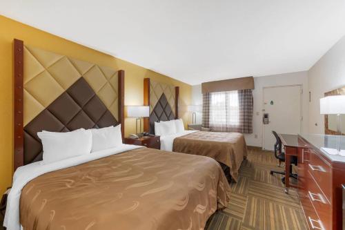 a hotel room with two beds and a sink at Quality Inn Florida City - Gateway to the Keys in Florida City