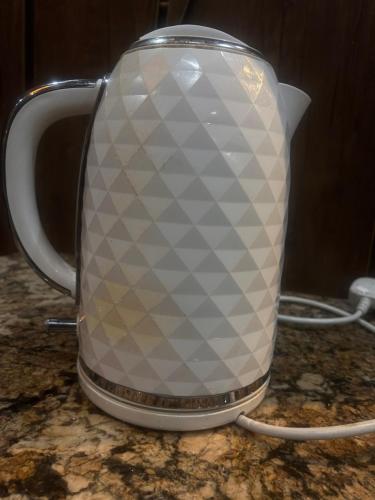 a tea kettle sitting on top of a counter at Laycon hotel and suites in Ikuata
