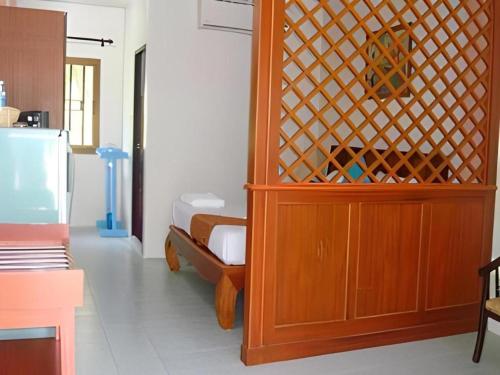a room with a wooden cabinet in a room at Nayai Resort in Chalong
