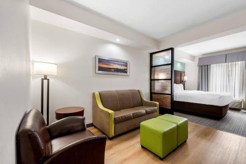 a hotel room with a couch and a bed at Comfort Suites New Bern near Cherry Point in New Bern