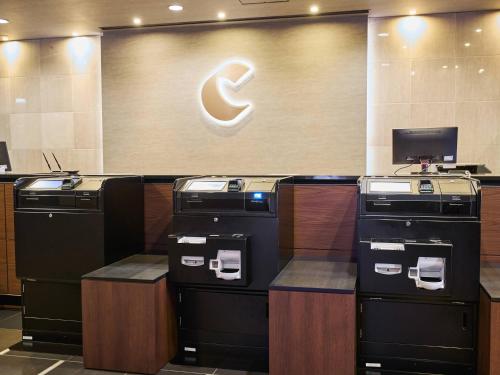 an office with four atm machines in a lobby at Comfort Hotel Sendai West in Sendai