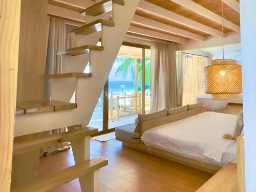 a bedroom with a bed and a view of the ocean at Tonsak Resort in Ko Samed