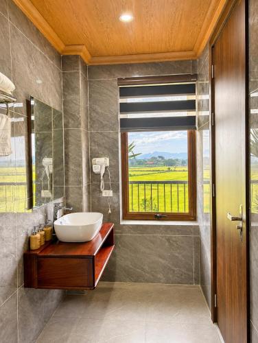 a bathroom with a sink and a window at Daisy's Villa TamCoc in Ninh Binh