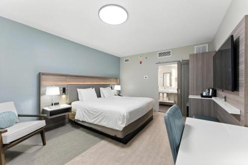 a bedroom with a bed and a couch and a table at Radisson Resort at the Port in Cape Canaveral