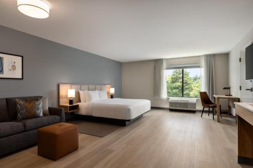 a hotel room with a bed and a couch at Hyatt Studios Chesapeake in Chesapeake