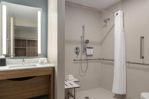 a bathroom with a shower and a sink at Hyatt Studios Chesapeake in Chesapeake