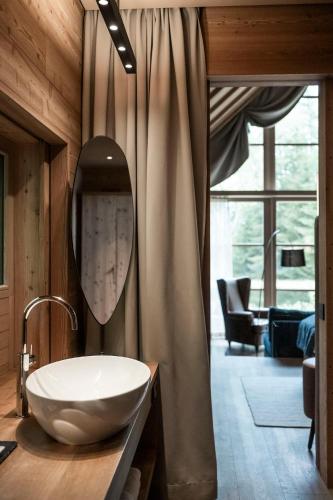 a bathroom with a sink and a mirror at ADLER Ritten in Soprabolzano