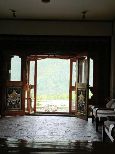 an open door to a room with a window at Drukyul Kora Tours & Treks in Thimphu