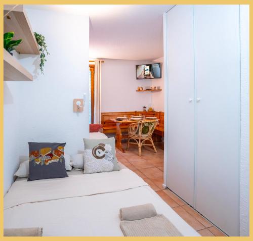 a room with two beds and a dining room at Chez Sebastien I Studio I Bernex in Bernex