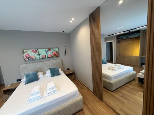 a hotel room with two beds and a mirror at SD House in Vlorë