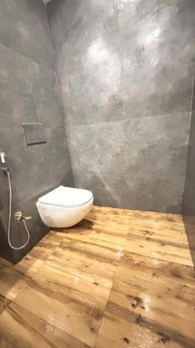 a bathroom with a toilet in the corner of a room at Hide Away Resort in Jhārgrām