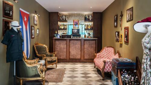 a room with a bar with chairs and a mannequin at Quba by Montraj Pattaya, previously The Quba Hotel Pattaya in Pattaya