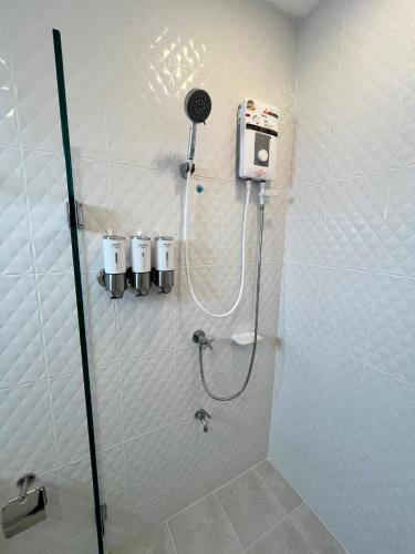 a shower stall in a bathroom with a shower at The Eiffel Cafe and Hotel in Ban Khlong Lat Bua Khao
