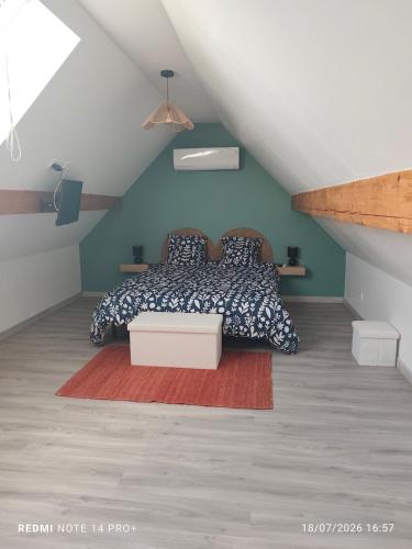a bedroom with a bed in a attic at La Cabane du Noyer in Morée