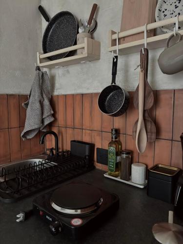 a kitchen with a stove and pots and pans at Casa Mayab in León