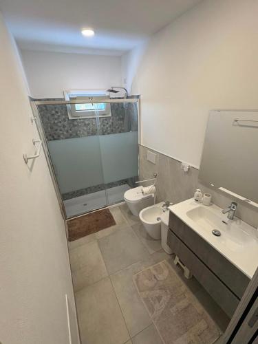 a bathroom with a shower and a toilet and a sink at Blue Sky Sardinia in Sorso