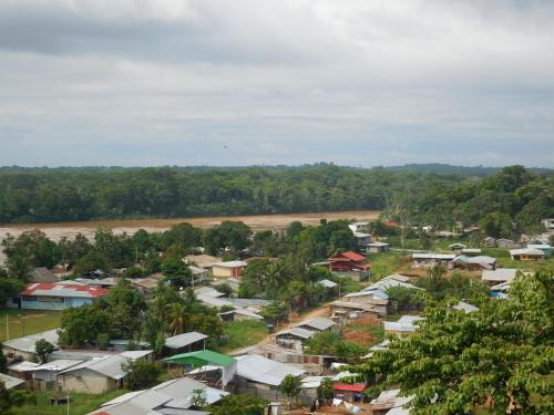 an overview of a village with a river and trees at Tambopata Hostel in Puerto Maldonado