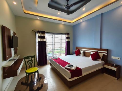 a bedroom with a large bed and a window at Sea Wander Beach Resort in Mandarmoni