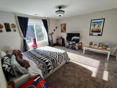 a bedroom with a bed and a tv in it at Evergreen House in Vancouver