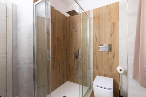a bathroom with a shower and a toilet at Comfyrooms in Quartu SantʼElena