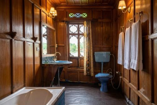 a bathroom with a tub and a toilet and a sink at Kashmir View group of Houseboat in Srinagar