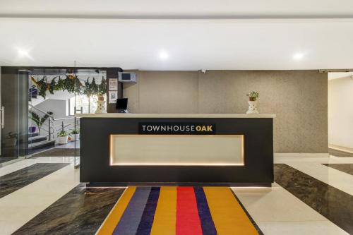 a lobby with a tumulus bank sign and a colorful rug at Hotel O D Suites in Hyderabad