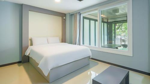 a bedroom with a white bed and a window at Gapeong Jason Spa Pension in Gapyeong