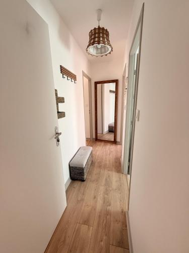 a hallway with a door and a ottoman on the floor at Appartement neuf à louer in Moyenmoutier