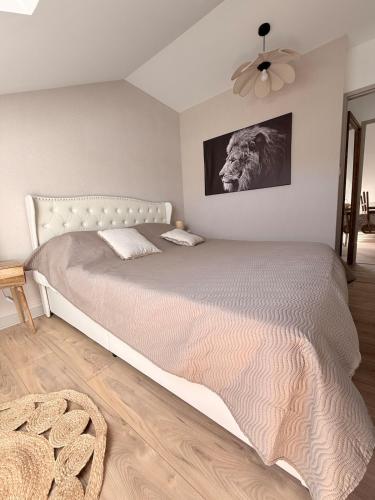 a bedroom with a bed with a lion picture on the wall at Appartement neuf à louer in Moyenmoutier