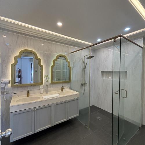 a bathroom with a sink and a glass shower at Queen Margarette Hotel in Silañgang Isabang