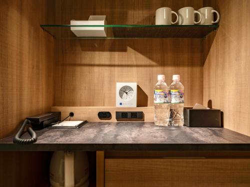 two bottles of water sitting on top of a counter at Meitetsu Inn Nagoyaeki Shinkansenguchi in Nagoya