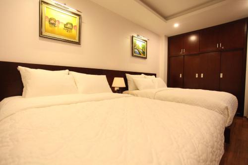 Ένα ή περισσότερα κρεβάτια σε δωμάτιο στο Camellia Hotel
