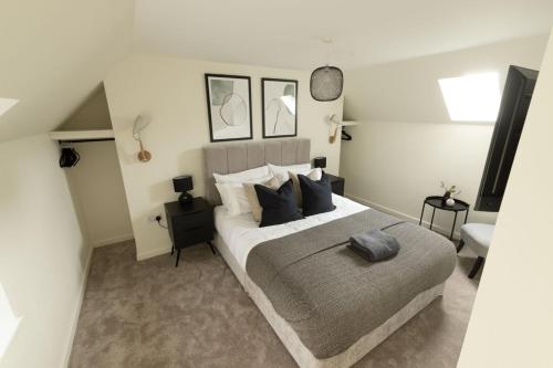 a bedroom with a large bed with pillows at Harbourside, Shetland Islands in Lerwick