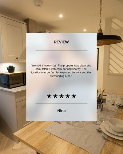 a picture of a kitchen with a sign that says review at Harbourside, Shetland Islands in Lerwick