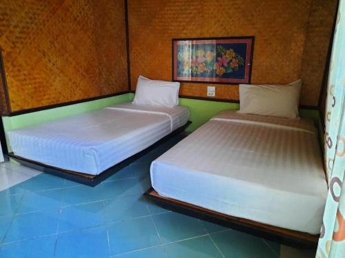 two beds are sitting in a room at Pangsarapee Resort in Ban Bo Nam Khao