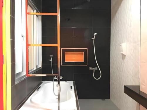 a bathroom with a sink and a shower with a mirror at Tanisa Resort in Na Dhung
