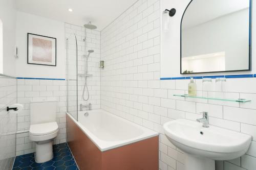 a white bathroom with a sink and a toilet at The Rodney Hotel in Bristol