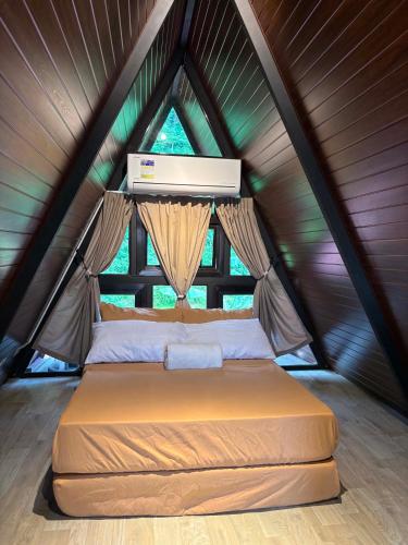 a bed in a tent with a window at Casa Carmelita in Batangas City