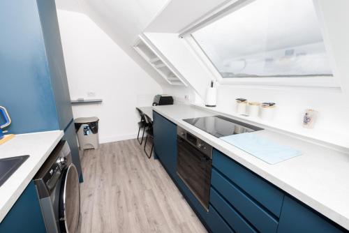 a kitchen with a sink and a window at North Harbour View, Shetland Islands in Lerwick