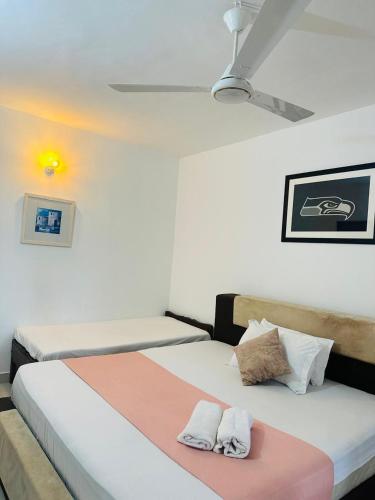 a bedroom with two beds and a ceiling at Villa 121 in Kandy