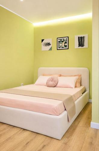 a large bed in a room with green walls at ЖК "Женис III" in Kokshetau